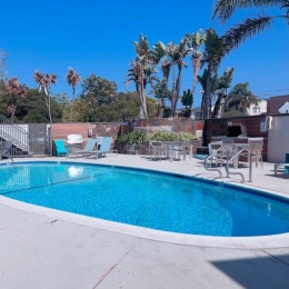 a swimming pool with lounge chairs