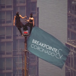 a man and a woman on the top of a flag pole